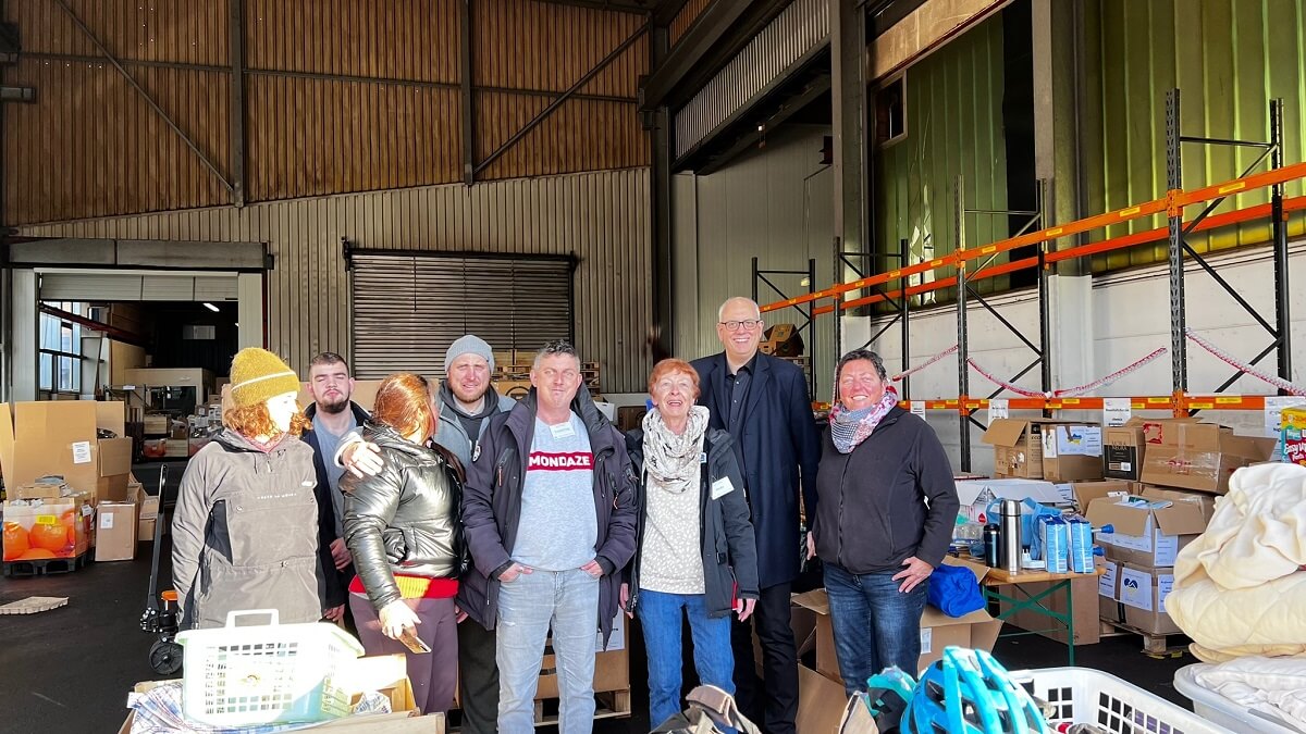 Bremens Bürgermeister in der Bremer Spendenstation mit dem ehrenamtlichen Team bestehend aus 7 Personen